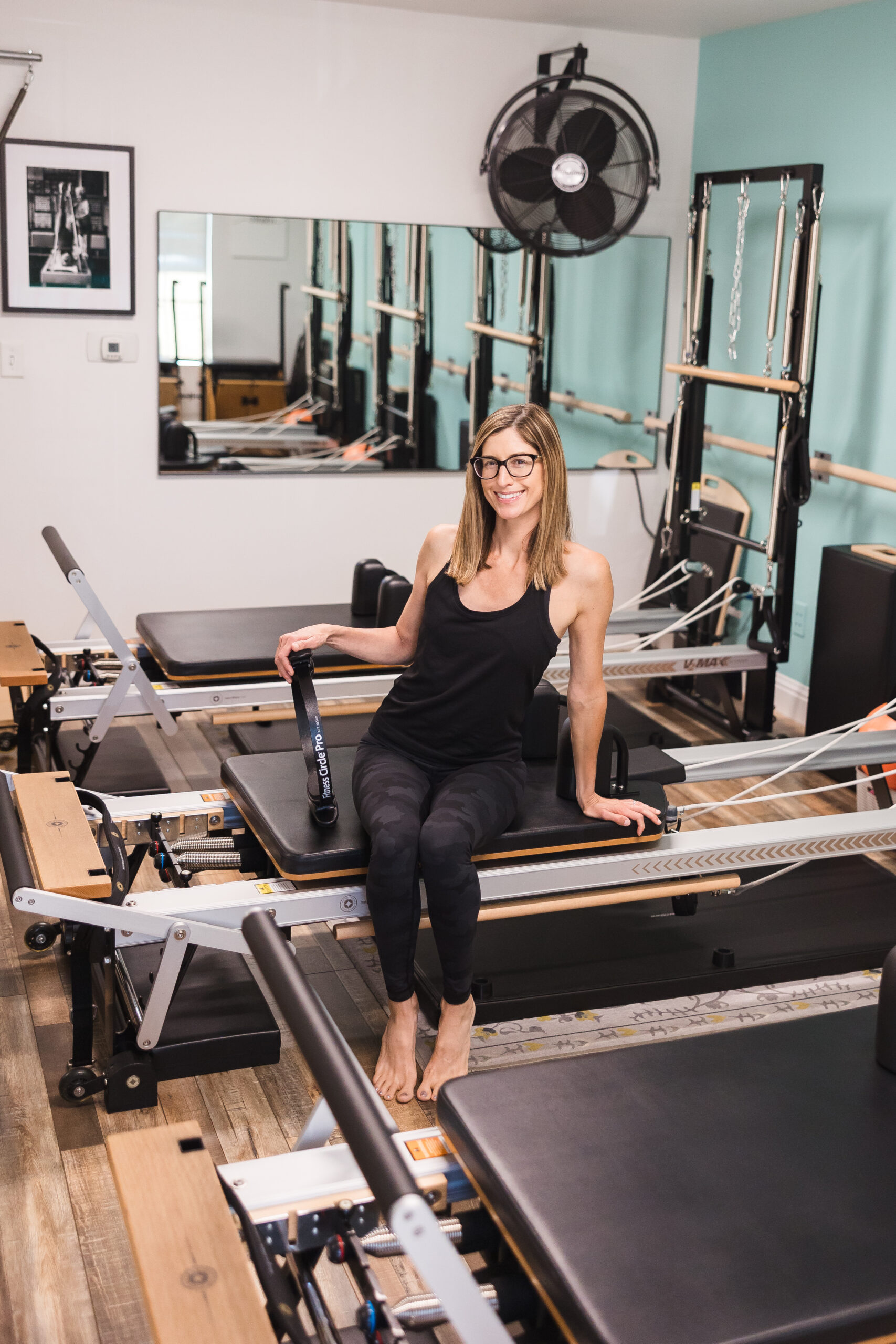 Peak Pilates - Pilates Trainer Exercising on Peak Pilates Reformer